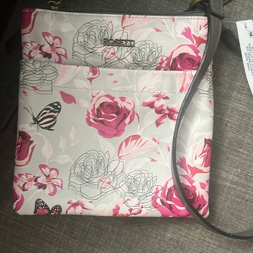 A purse has flowers and pockets